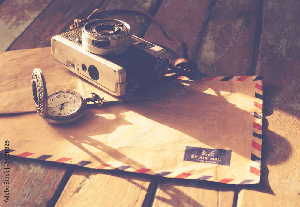 Vintage travel background, old film camera ,antique watches and airmail letter on wood table, instagram effect filter