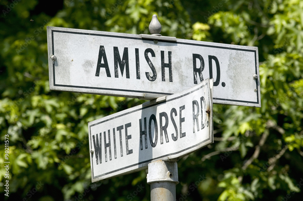 Amish horse and carriage driving past barn in Lancaster County, Pennsylvania Amish horse and carriage driving past barn in Lancaster County, Pennsylvania