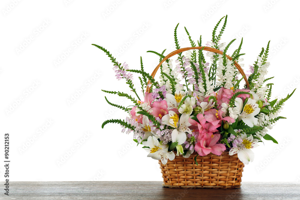 Beautiful floral arrangement in basket isolated on white