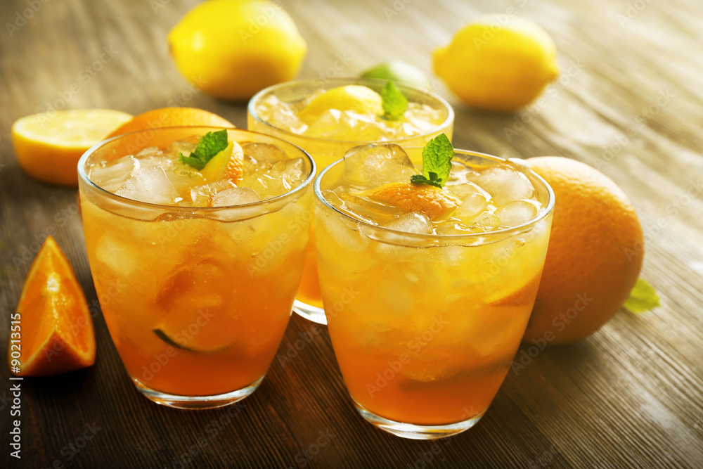 Glasses of orange juice on wooden table, closeup Glasses of orange juice on wooden table, closeup