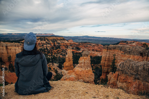 Girl sitting on cliff edge at Bryce Canyon