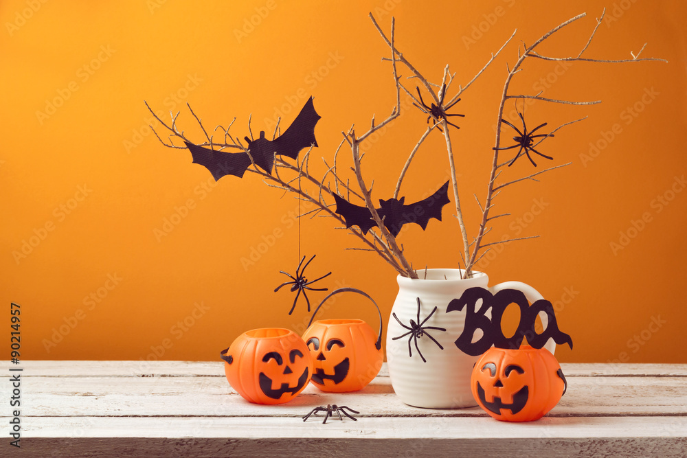 Fototapeta premium Halloween home decorations with spiders and pumpkin bucket for trick or treat