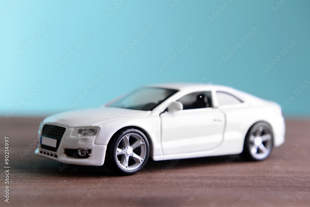 Small toy car on blue background