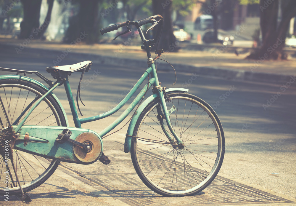 Vintage Bicycle parked on the city Street (film look instagram effect)