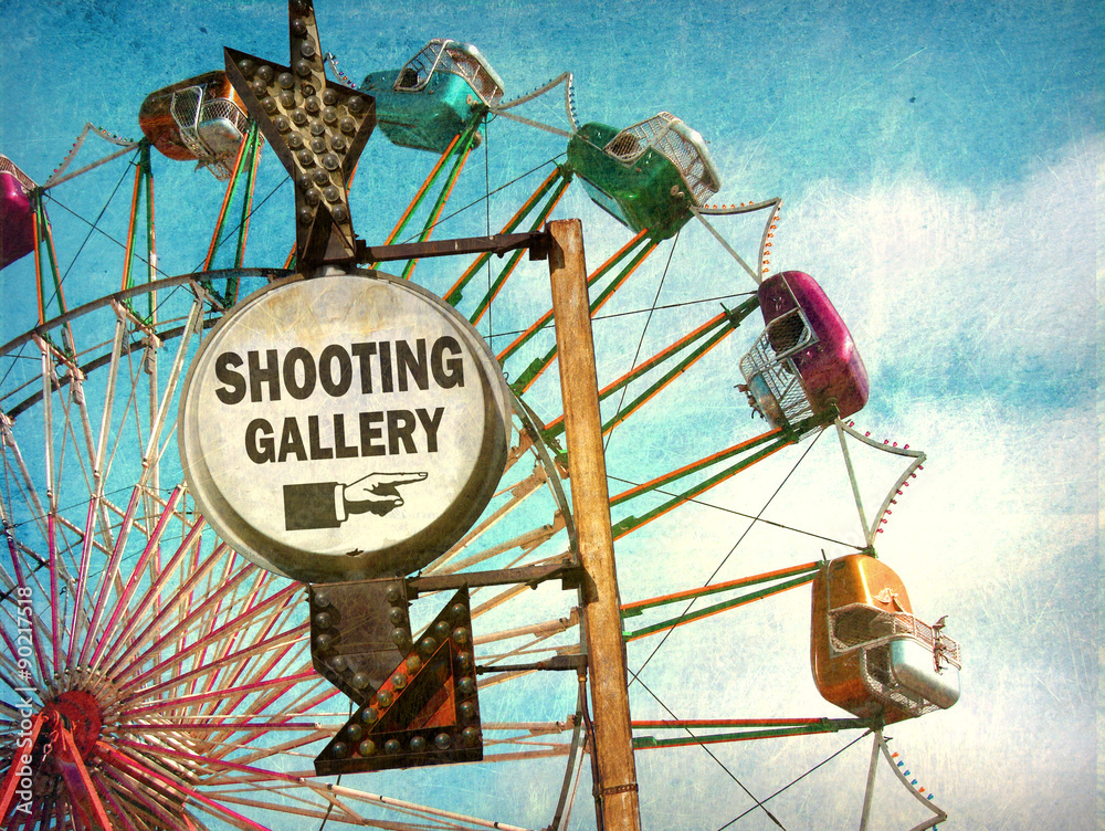 aged and worn vintage photo of shooting gallery sign at carnival Stock