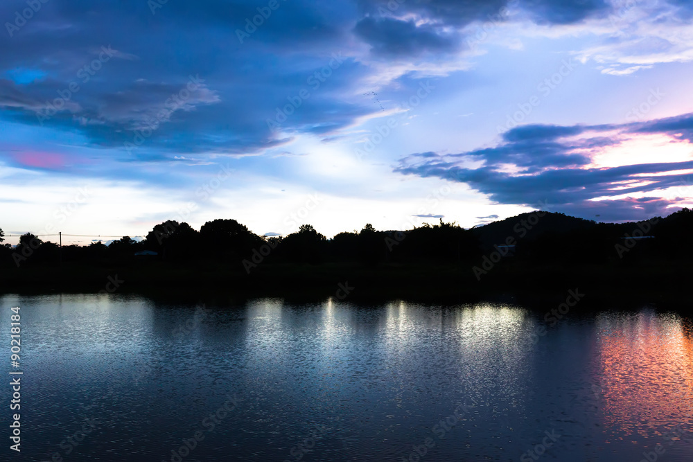 Reflection magic of colour sky and cloud in the river at twiligh