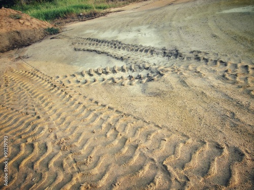 Wheel tracks on the soil.