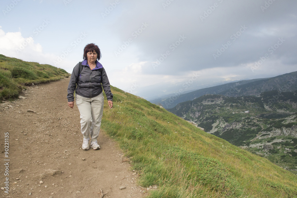 Senior woman walking in the mountain Senior woman walking in the mountain