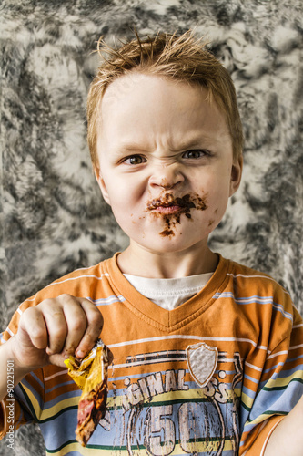 The boy's mouth with chocolate