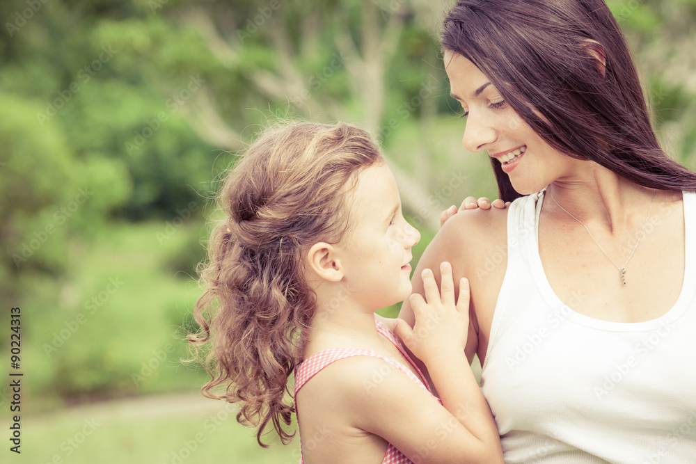 Happy mother and daughter playing in the park at the day time. Happy mother and daughter playing in the park at the day time.