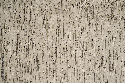 Texture of cream plaster wall in form of raindrops