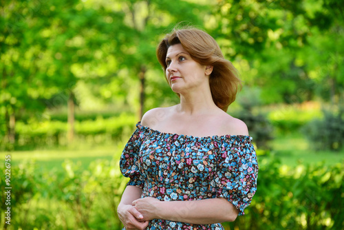 stylish middle-aged woman in the summer park