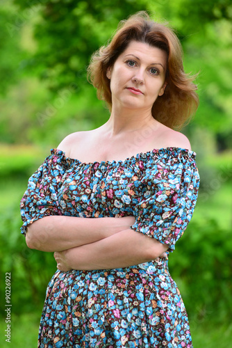 stylish middle-aged woman in the summer park