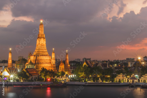 Blurry photograph of Wat Arun or temple of dawn at twilight in Bangkok, Thailand, Blurry abstract background.