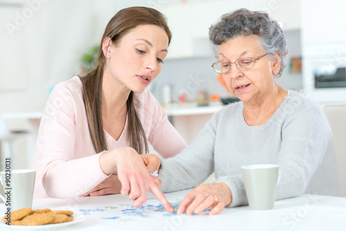 Old lady doing a jigsaw puzzle