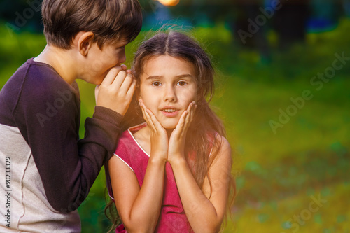 boy girl whispers in the ear secret rumors says in nature photos