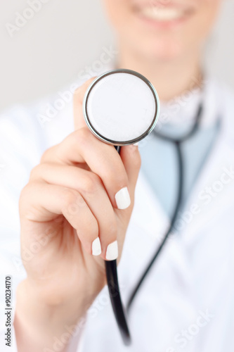 Professional doctor holding stethoscope