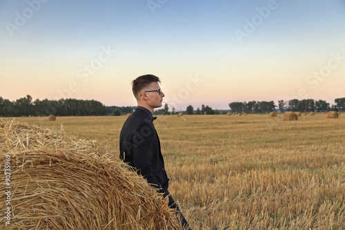 Young man with glasses on the field