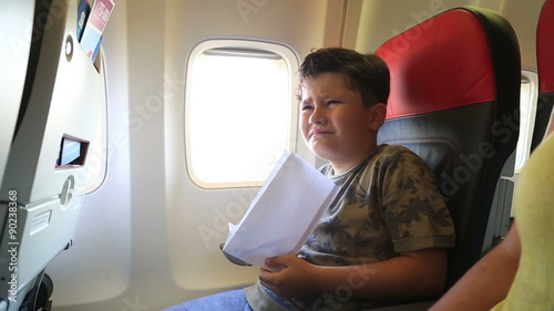 Cute boy getting sick in an airplane photo