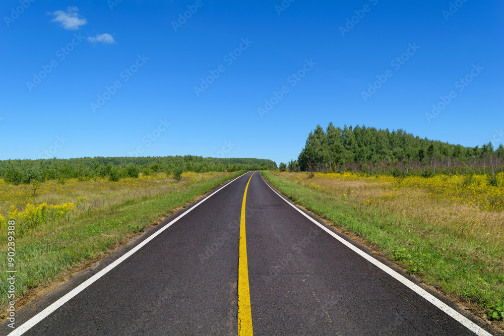 Country asphalt highway with one line of yellow and two line of solid white road markings