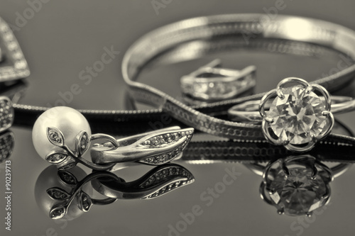 gold ring, earrings and chains. Sepia