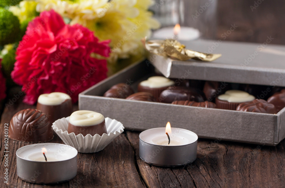 chocolate candy, candles and flowers
