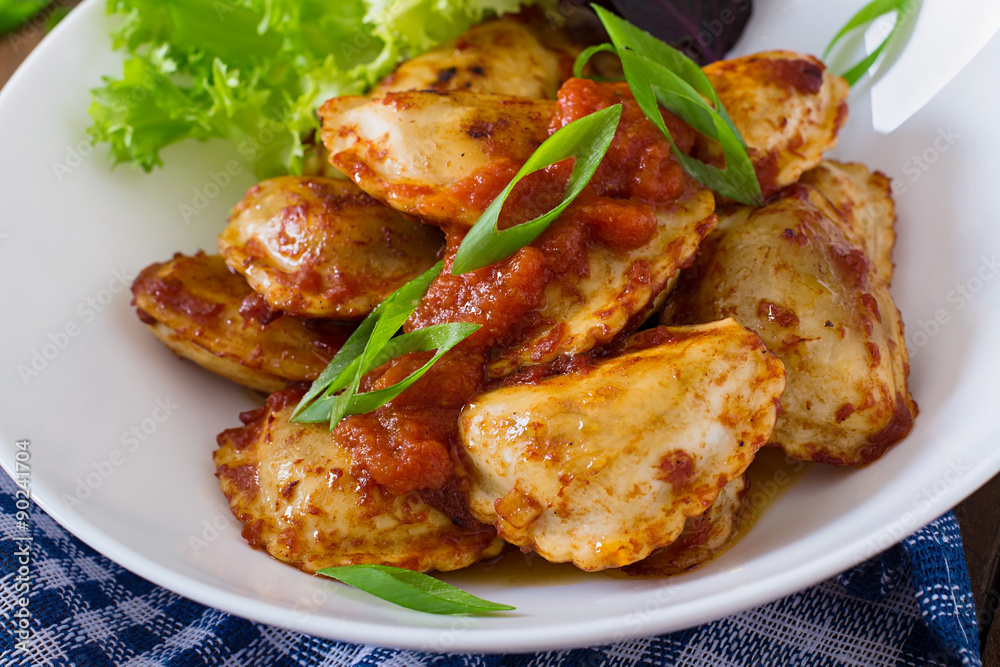 Delicious ravioli with tomato sauce and green onions Delicious ravioli with tomato sauce and green onions