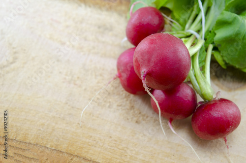 Raw radishes on a wooden board