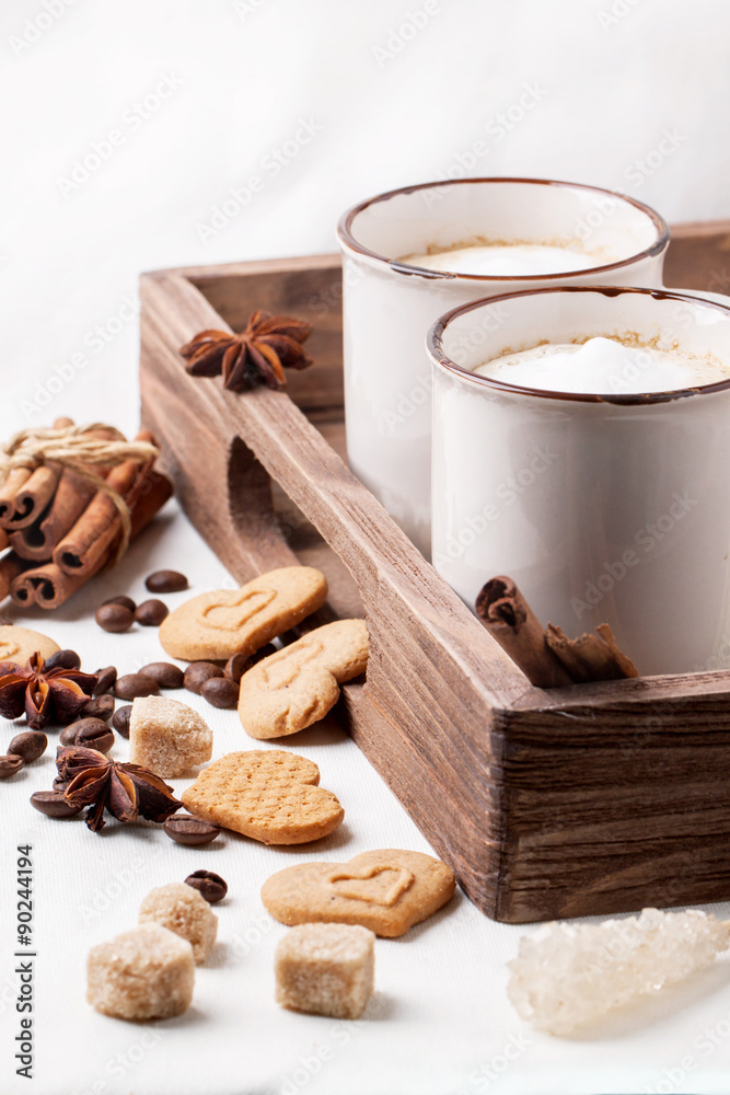 Tow cup of cappuccino with cookies as hearts Tow cup of cappuccino with cookies as hearts