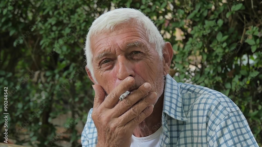 portrait of a senior man smoking a cigarette outdoor slow motion portrait of a senior man smoking a cigarette outdoor slow motion