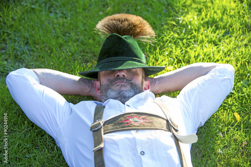 bavarian man sleeping on the grass