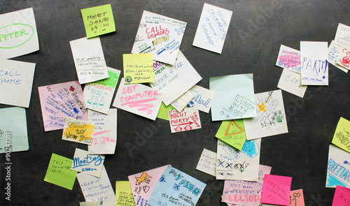 Post-it notes on dark background - busy concept