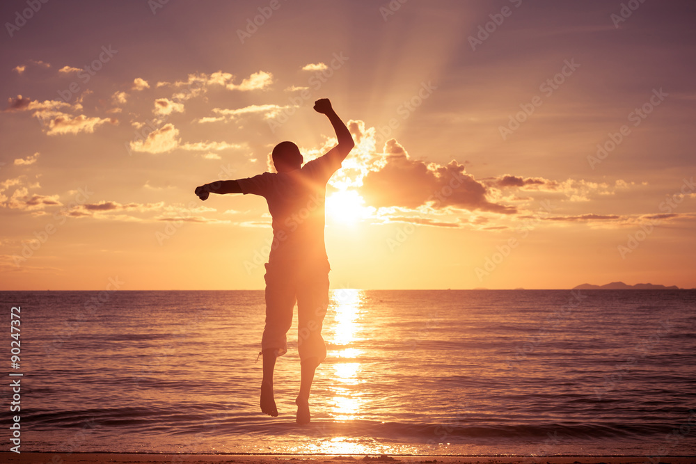 Fototapeta premium Man with his hands up on the beach