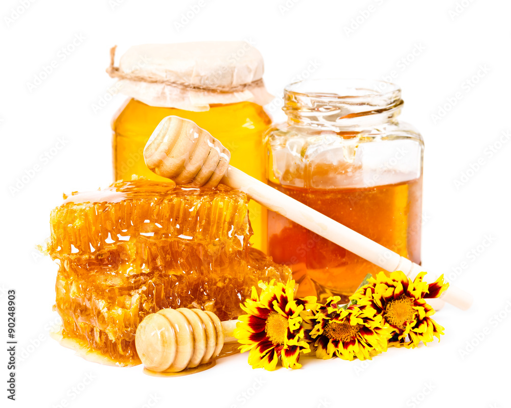 Sweet honeycomb and jars of honey with stick and flowers Sweet honeycomb and jars of honey with stick and flowers