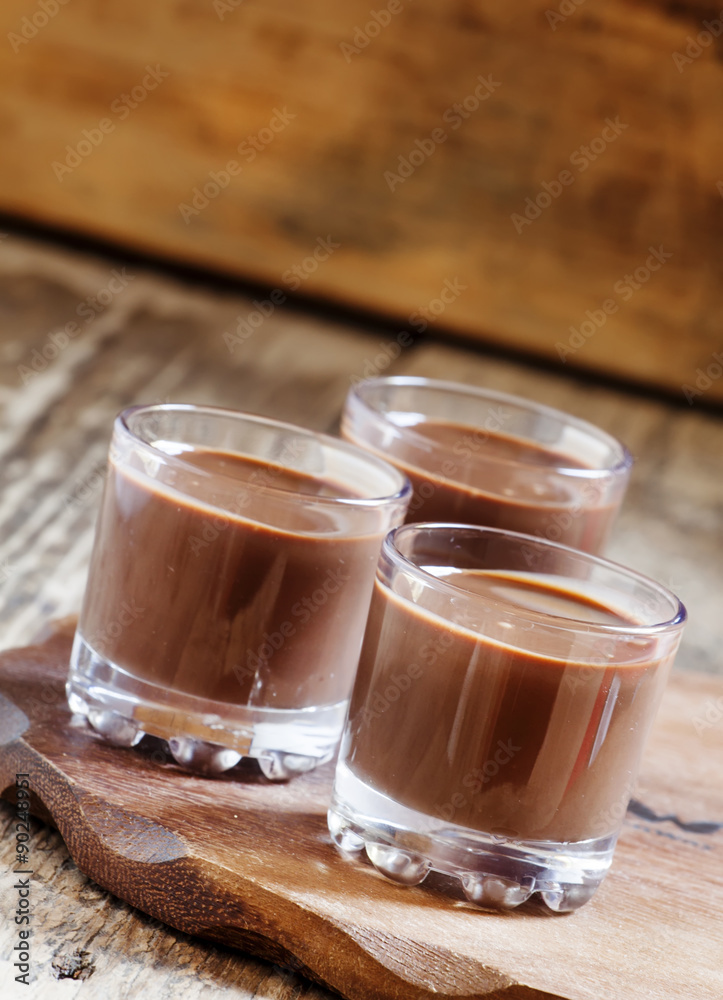 Liquid chocolate in a glass on the old wooden background, select Liquid chocolate in a glass on the old wooden background, select