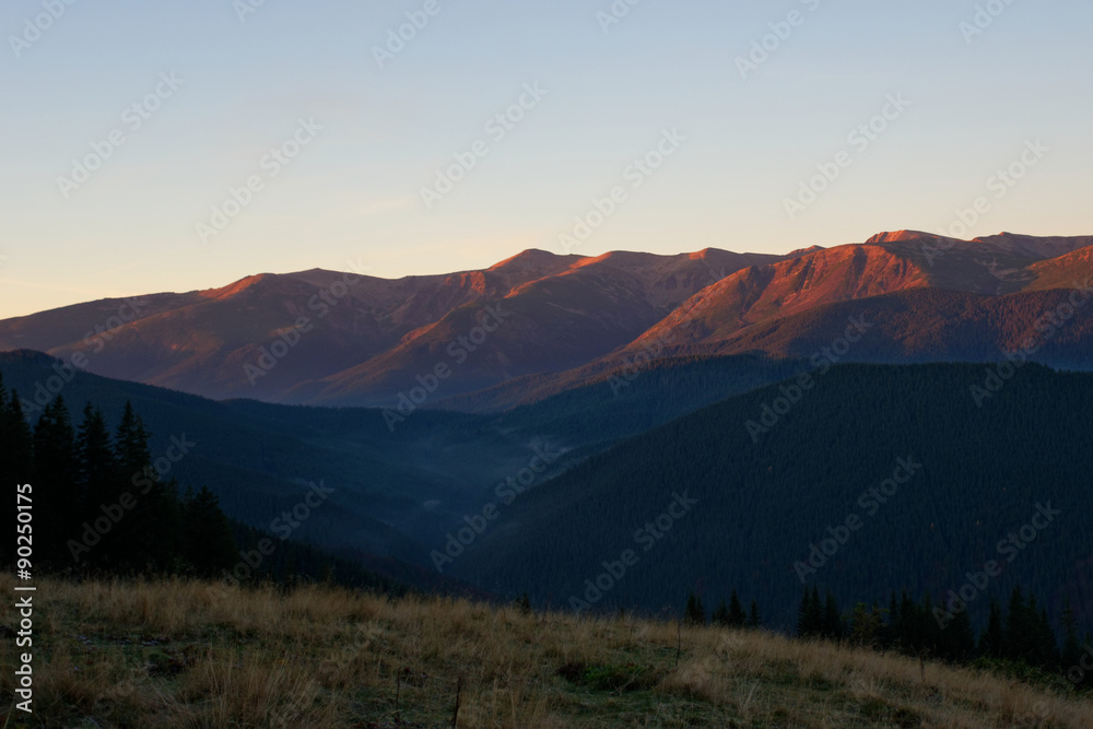 View of rosy mountain peaks of Chornogora range in Carpathians at the sunrise