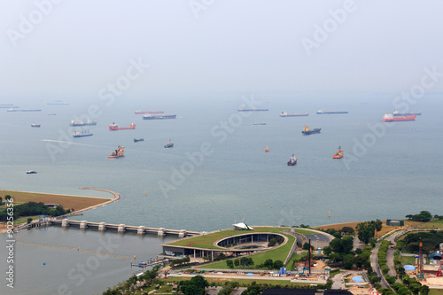 Canvas Print Marina Barrage dam and cargo ships lying in the roads off the coast of Singapore