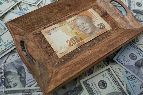 a tray of twenty rand and dollars