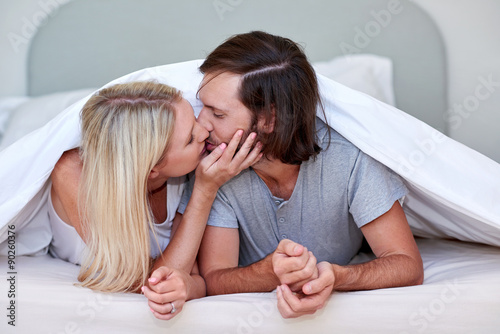 couple kiss bedroom