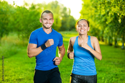 Fototapeta Naklejka Na Ścianę i Meble -  Runners training outdoors working out. City running couple