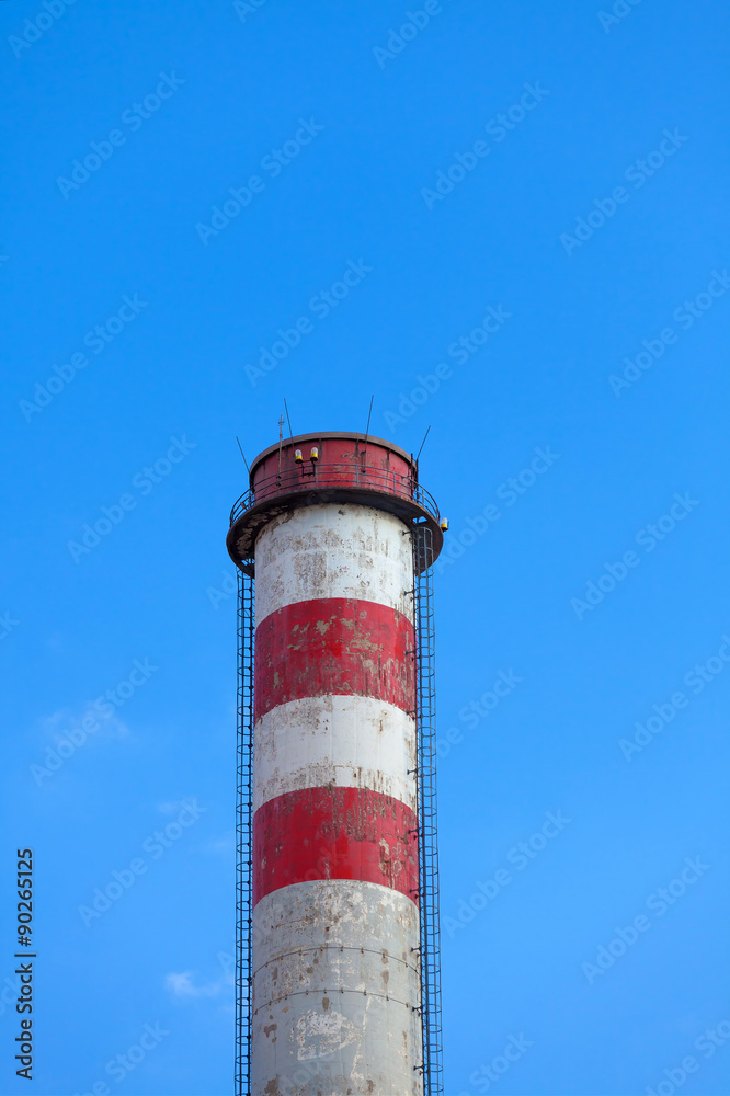 
A single industrial chimney, blue sky
