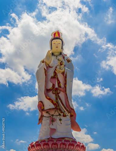 Statue of the Goddess Guanyin against blue sky photo