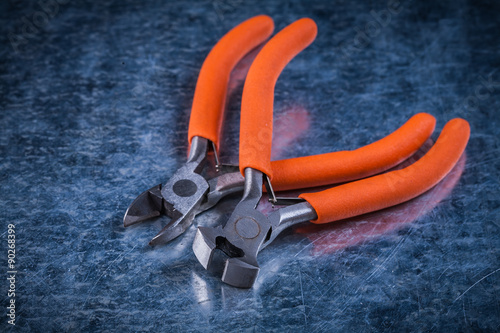 Insulated electric sharp nippers on metallic surface constructio