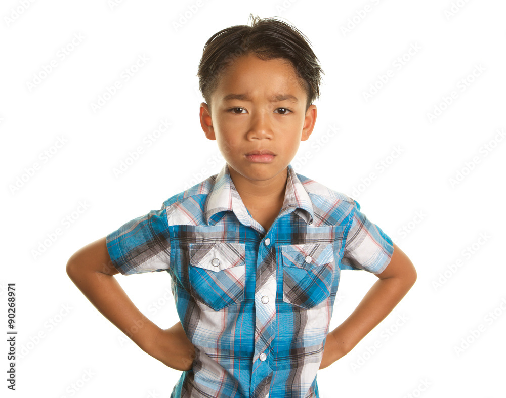 Cute Filipino Boy on a White Background with an unhappy,serious expression Cute Filipino Boy on a White Background with an unhappy,serious expression