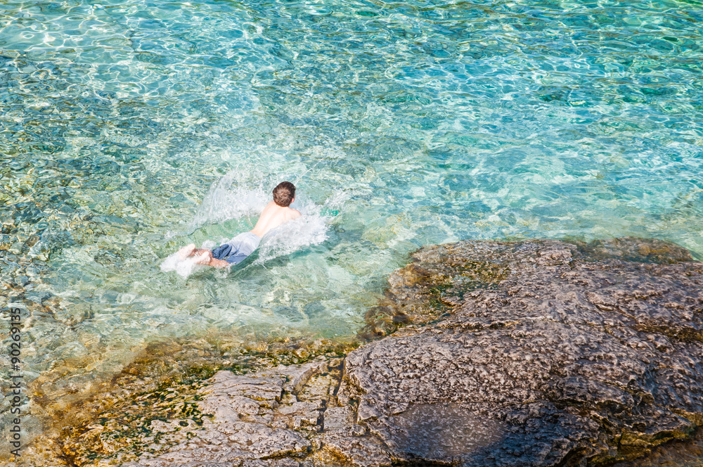 young boy swimming in the clear clean waters of the Bruce Peninsula National Park
