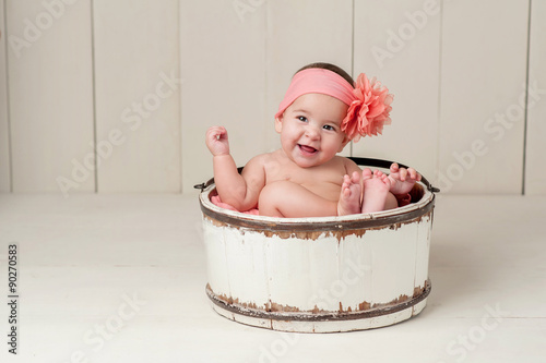 Laughing Baby Girl in Wooden Bucket