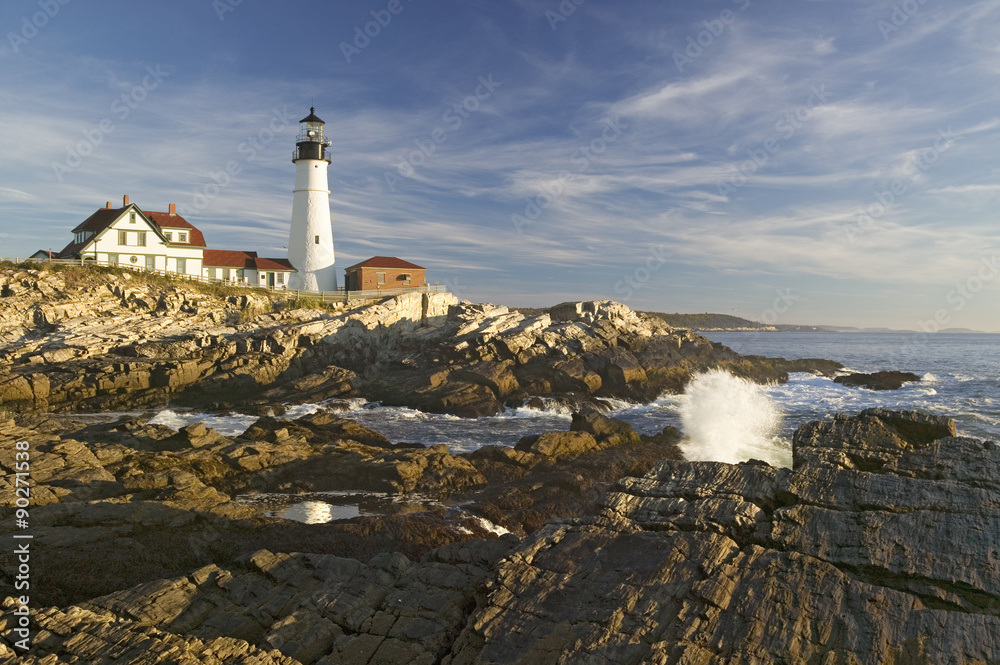 Sunrise view of Portland Head Lighthouse and ocean wave, Cape Elizabeth, Maine