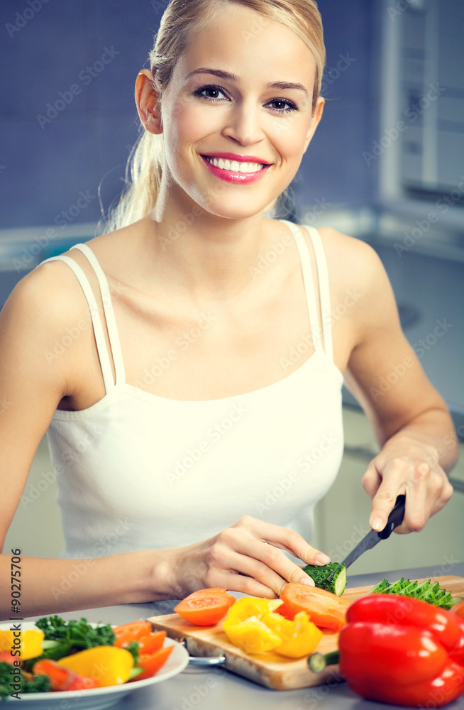 woman making salad at domestic kitchen woman making salad at domestic kitchen