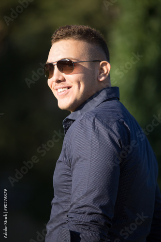 Cheerful young man in sunglasses