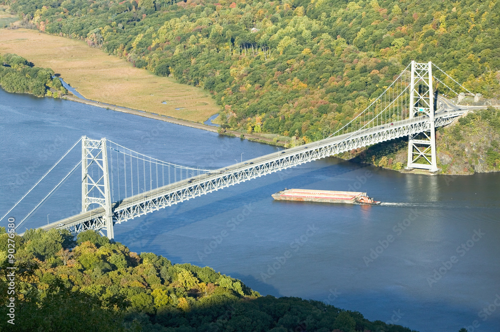 Autumn view overlook of Bear Mountain Bridge, trash barge and Hudson Valley and River at Bear Mountain State Park, New York